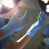 1-midsection-view-of-hands-in-surgical-gloves-and-surgical-lights-in-the-operating-room-xixinxing Latex Gloves