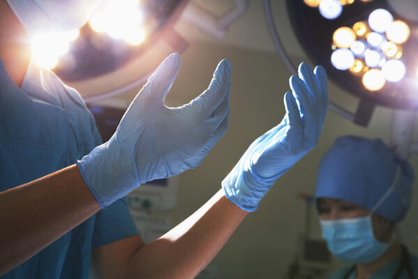 1-midsection-view-of-hands-in-surgical-gloves-and-surgical-lights-in-the-operating-room-xixinxing Latex Gloves