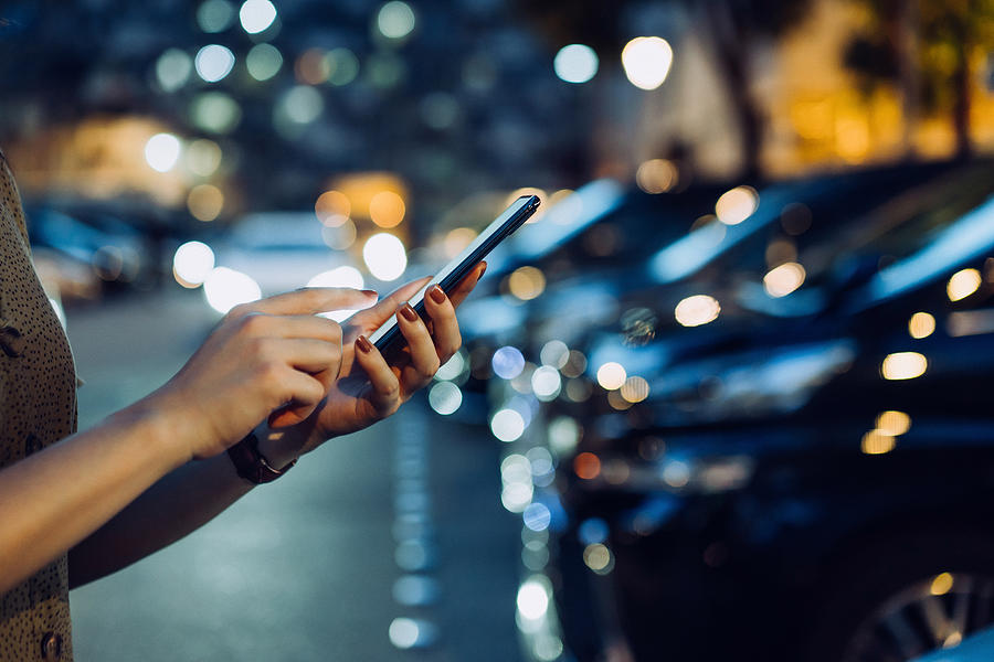 cropped-shot-of-a-womans-hand-using-smartphone-while-walking-to-her-car-in-car-park-in-city-at-night-d3sign 30–60 Gallon Trash Bags