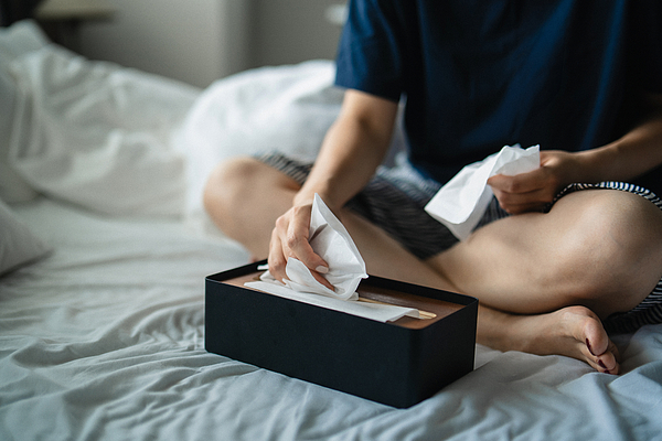 cropped-shot-of-woman-feeling-ill-suffering-from-cold-flu-and-allergy-grabbing-facial-tissues-from-the-box-on-bed-concept-of-health-and-illness-d3sign Facial Tissue
